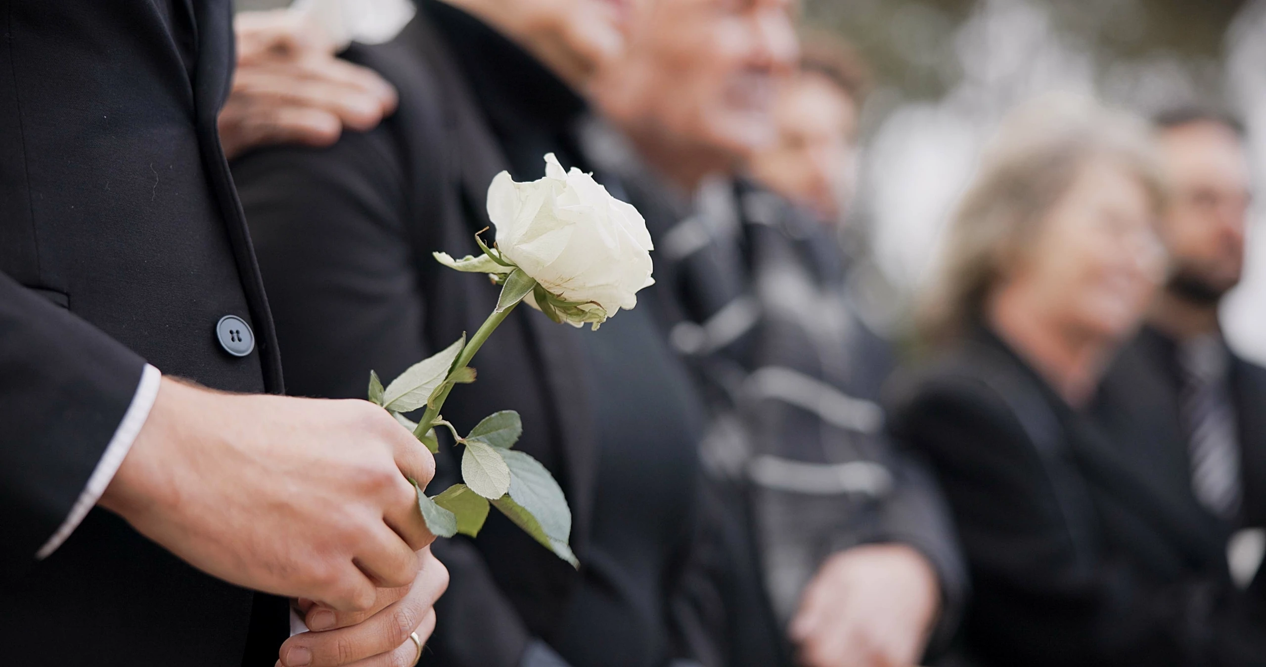 people in black clothes at a wrongful death funeral